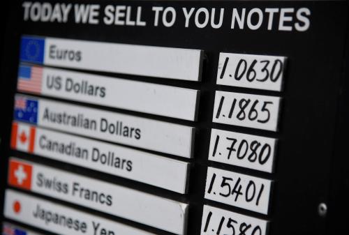 A board displaying buying and selling rates is seen outside of a currency exchange outlet on July 31, 2019.