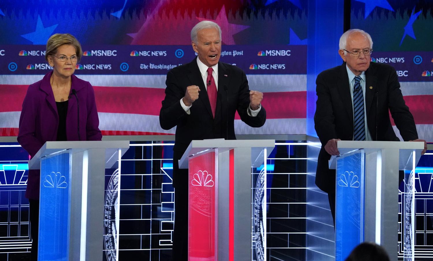 Democratic U.S. presidential candidate and former Vice President Joe Biden speaks as Senator Elizabeth Warren and Senator Bernie Sanders listen during the fifth 2020 campaign debate at the Tyler Perry Studios in Atlanta, Georgia, U.S., November 20, 2019. REUTERS/Brendan McDermid - HP1EFBL0D2F2W