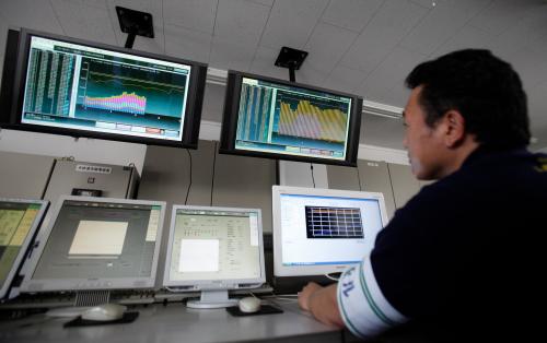 An employee of Nissan Motor Co monitors real-time power usage data at the company's facilities at the Oppama plant in Yokosuka, south of Tokyo July 2, 2011. With 35 of Japan's 54 nuclear power plants shut, the Japanese government has ordered big companies to cut their peak power consumption by 15 percent from last year this summer, in the first such mandate since the oil crisis of 1974. To meet the target, the auto industry has changed its weekend holidays to Thursdays and Fridays between July and September.   REUTERS/Yuriko Nakao (JAPAN - Tags: TRANSPORT ENERGY) - GM1E7721AIH01