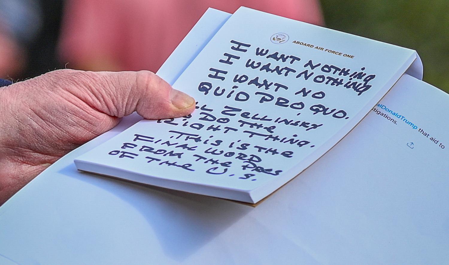 U.S. President Donald Trump holds what appears to be a prepared statement and handwritten notes after watching testimony by U.S. Ambassador to the European Union Gordon Sondland as he speaks to reporters prior to departing for travel to Austin, Texas from the South Lawn of the White House in Washington, U.S., November 20, 2019. REUTERS/Erin Scott - RC26FD9ITUXN