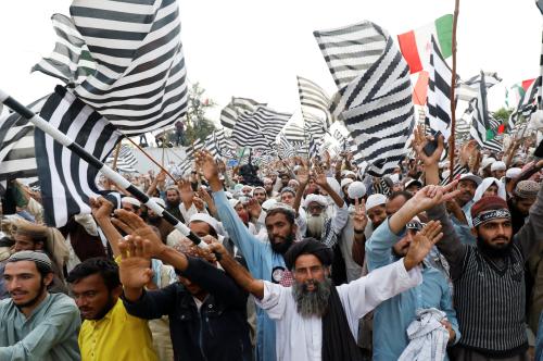 Supporters of religious and political party Jamiat Ulema-i-Islam-Fazal (JUI-F) wave flags and chant slogans during what participants call Azadi March (Freedom March) to protest the government of Prime Minister Imran Khan in Islamabad, Pakistan November 2, 2019. REUTERS/Akhtar Soomro - RC14C39D0790