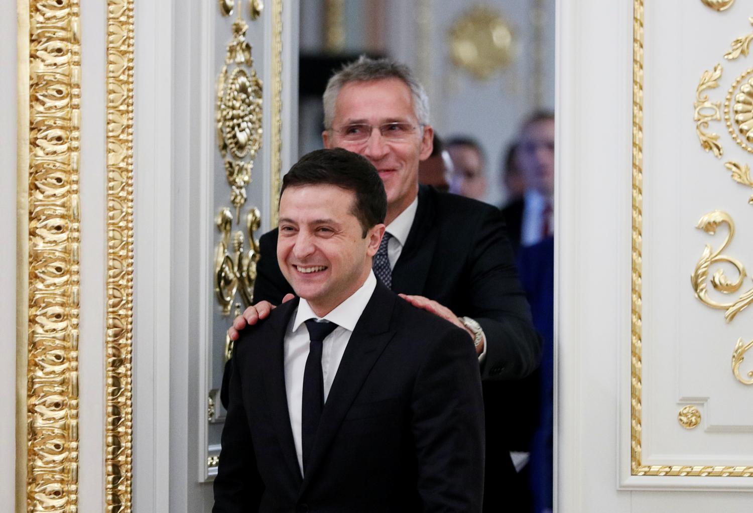 Ukrainian President Volodymyr Zelenskiy and NATO Secretary-General Jens Stoltenberg react while entering a hall following their talks in Kiev, Ukraine October 31, 2019. REUTERS/Gleb Garanich - RC178AF29120