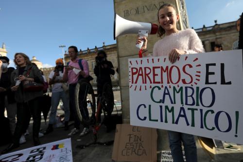 A girl holds a sign that reads: "Let's stop climate change", during a protest against climate change in Bogota, Colombia May 24, 2019. REUTERS/Luisa Gonzalez - RC1BF6638B60