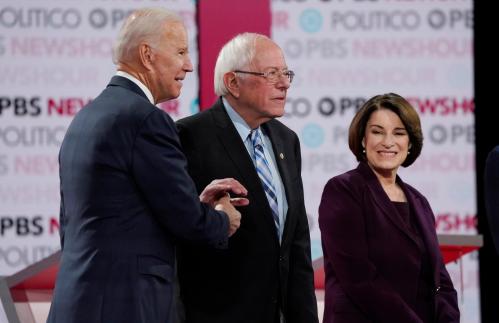 Democratic U.S. presidential candidate and former Vice President Joe Biden greets Senator Bernie Sanders as Senator Amy Klobuchar looks on at the 2020 campaign debate at Loyola Marymount University in Los Angeles, California, U.S., December 19, 2019. REUTERS/Mike Blake - HP1EFCK02SG02