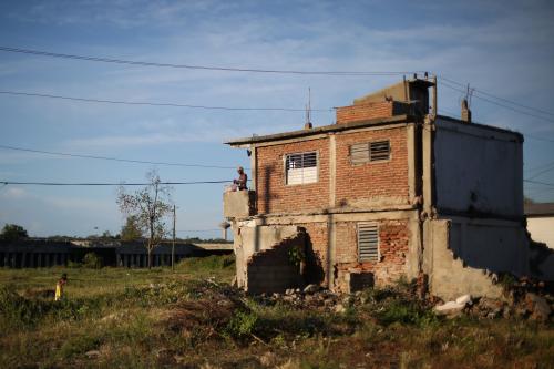 A woman washes clothes near Santa Ifigenia cemetery where the cortege carrying the ashes of Cuba's late President Fidel Castro is headed, in Santiago de Cuba, Cuba, December 4, 2016. REUTERS/Edgard Garrido - RC12C729B090