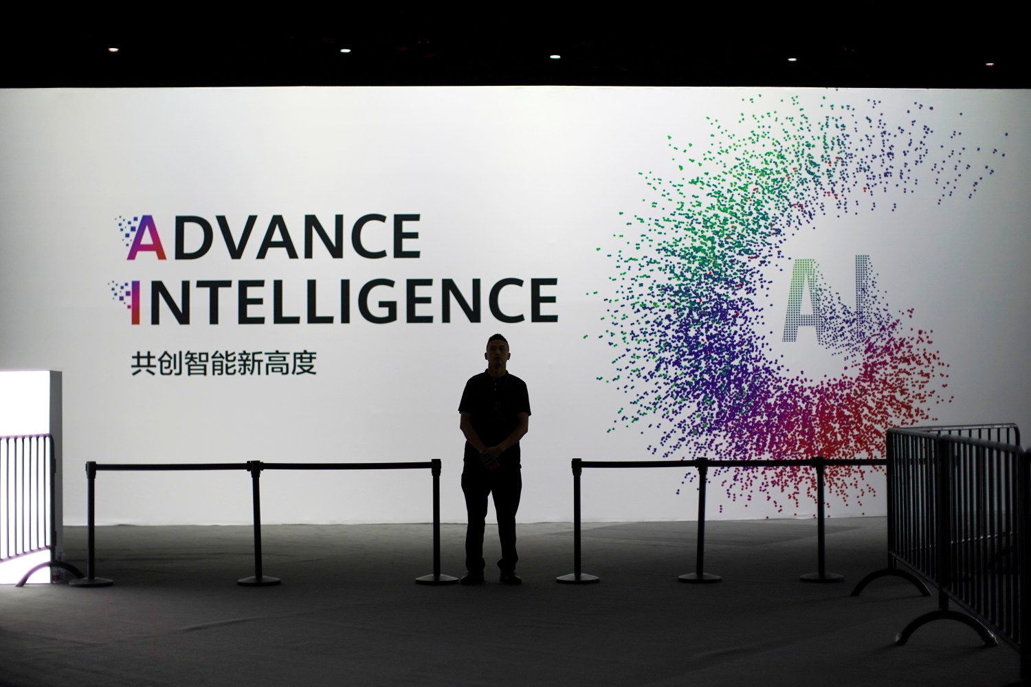 A security officer keeps watch in front of an AI (Artificial Intelligence) sign at the annual Huawei Connect event in Shanghai, China September 18, 2019. REUTERS/Aly Song - RC192A130D00