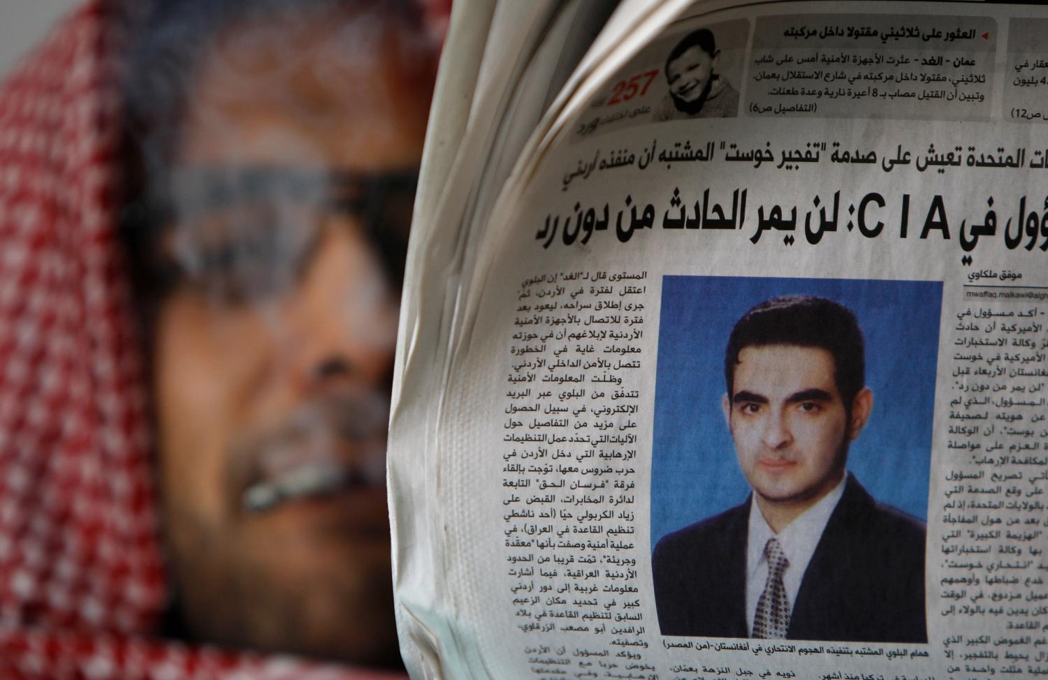 A man reads a copy of the day's newspaper whose front page shows a photo of suspected suicide bomber Humam Khalil Abu-Mulal al-Balawi in Amman January 9, 2010. A Pakistan television station on Saturday showed what it said was the suicide bomber double agent who killed CIA agents in Afghanistan sitting with the Pakistani Taliban leader, and reported he shared U.S. and Jordanian state secrets with militants. REUTERS/Ali Jarekji (JORDAN - Tags: CIVIL UNREST CRIME LAW POLITICS) - GM1E6191K0J01