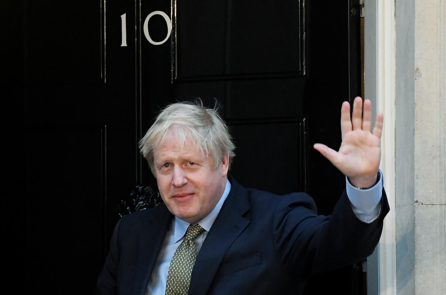 Britain's Prime Minister Boris Johnson waves after delivering a statement at Downing Street following winning the general election, in London, Britain, December 13, 2019. REUTERS/Toby Melville - RC2FUD9K5160