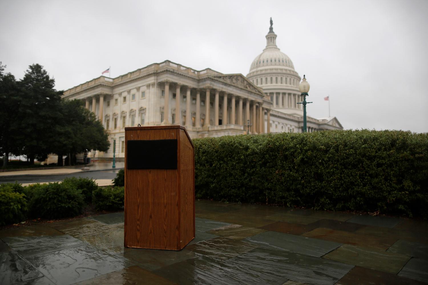 An empty speaker's lectern is seen in the rain outside the U.S. Capitol in Washington, October 10, 2013.  U.S. House of Representatives Republicans are weighing a short-term debt limit increase with no added policy changes, such as deficit-reduction requirements, according to a source with knowledge of the discussions. REUTERS/Jonathan Ernst (UNITED STATES - Tags: POLITICS BUSINESS) - GM1E9AA1RTL01