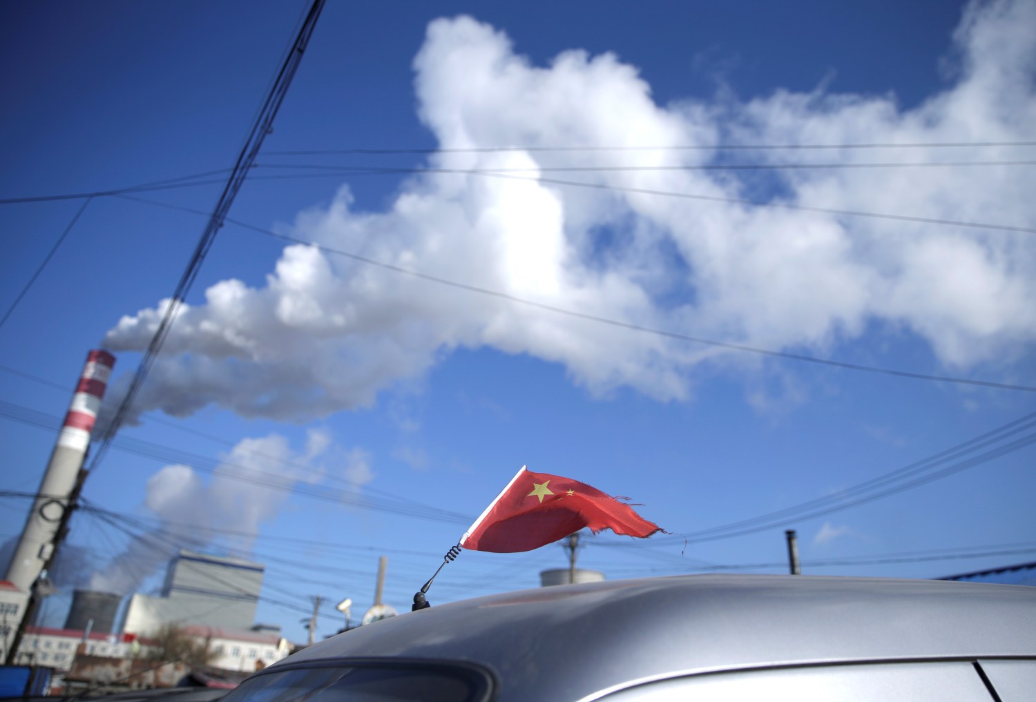 A Chinese flag is seen on the top of a car near a coal-fired power plant in Harbin, Heilongjiang province, China November 27, 2019. Picture taken November 27, 2019. REUTERS/Jason Lee u000d - RC2UKD9SW3H2