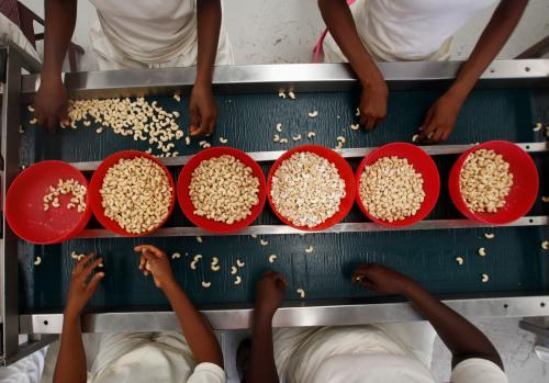 Workers handle cashew nuts at a processing plant in Bouake February 23, 2012. REUTERS/ Thierry Gouegnon (IVORY COAST - Tags: SOCIETY) - GM1E82O02D001