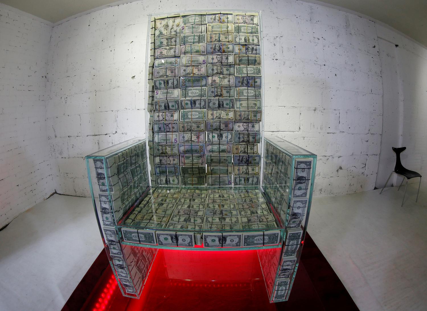 Art object "Money throne x10", a glass throne filled with $1 million, created by Russian artist Alexey Sergienko and entrepreneur Igor Rybakov, is seen during a presentation in Moscow Russia November 29, 2019. Picture taken November 29, 2019. REUTERS/Tatyana Makeyeva - RC2NLD9CFZXA