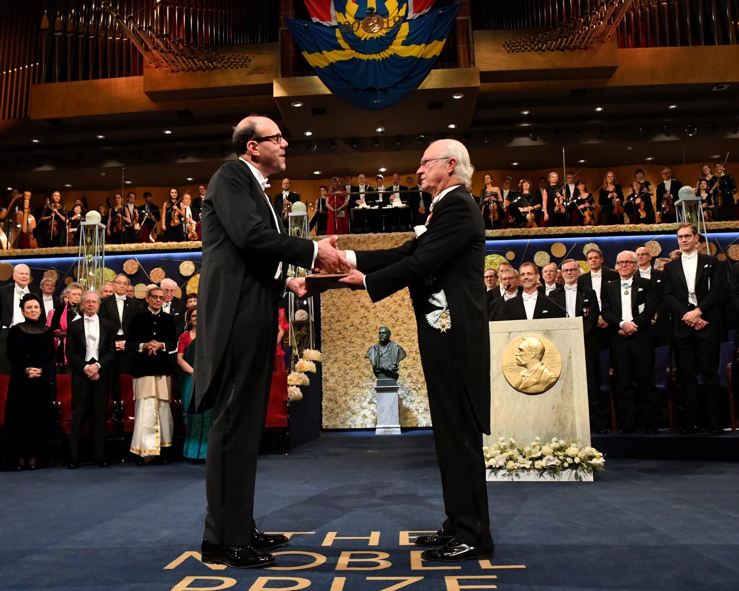 American economist Michael Kremer shakes hands with Sweden's King Carl Gustaf as he receives the Sveriges Riksbank Prize in Economic Sciences in Memory of Alfred Nobel during the Nobel Prize award ceremony at the Stockholm Concert Hall in Stockholm, Sweden December 10, 2019.   TT News Agency/Jonas Ekstromer via REUTERS      ATTENTION EDITORS - THIS IMAGE WAS PROVIDED BY A THIRD PARTY. SWEDEN OUT. NO COMMERCIAL OR EDITORIAL SALES IN SWEDEN. - RC2ISD9XOYP8