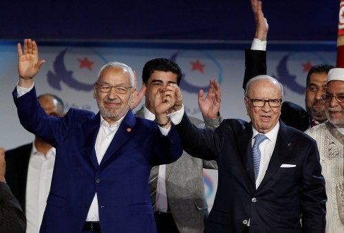 Tunisian President Beji Caid Essebsi (R) and Rached Ghannouchi, leader of the Islamist Ennahda movement, gesture during a congress of the Ennahda movement in Tunis,Tunisia May 20, 2016. Zoubeir Souissi