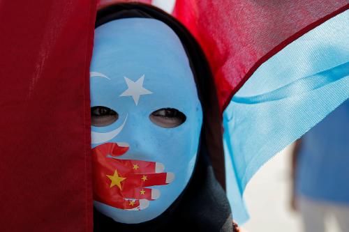 An ethnic Uighur demonstrator wears a mask as she attends a protest against China in front of the Chinese Consulate in Istanbul, Turkey, October 1, 2019. REUTERS/Huseyin Aldemir