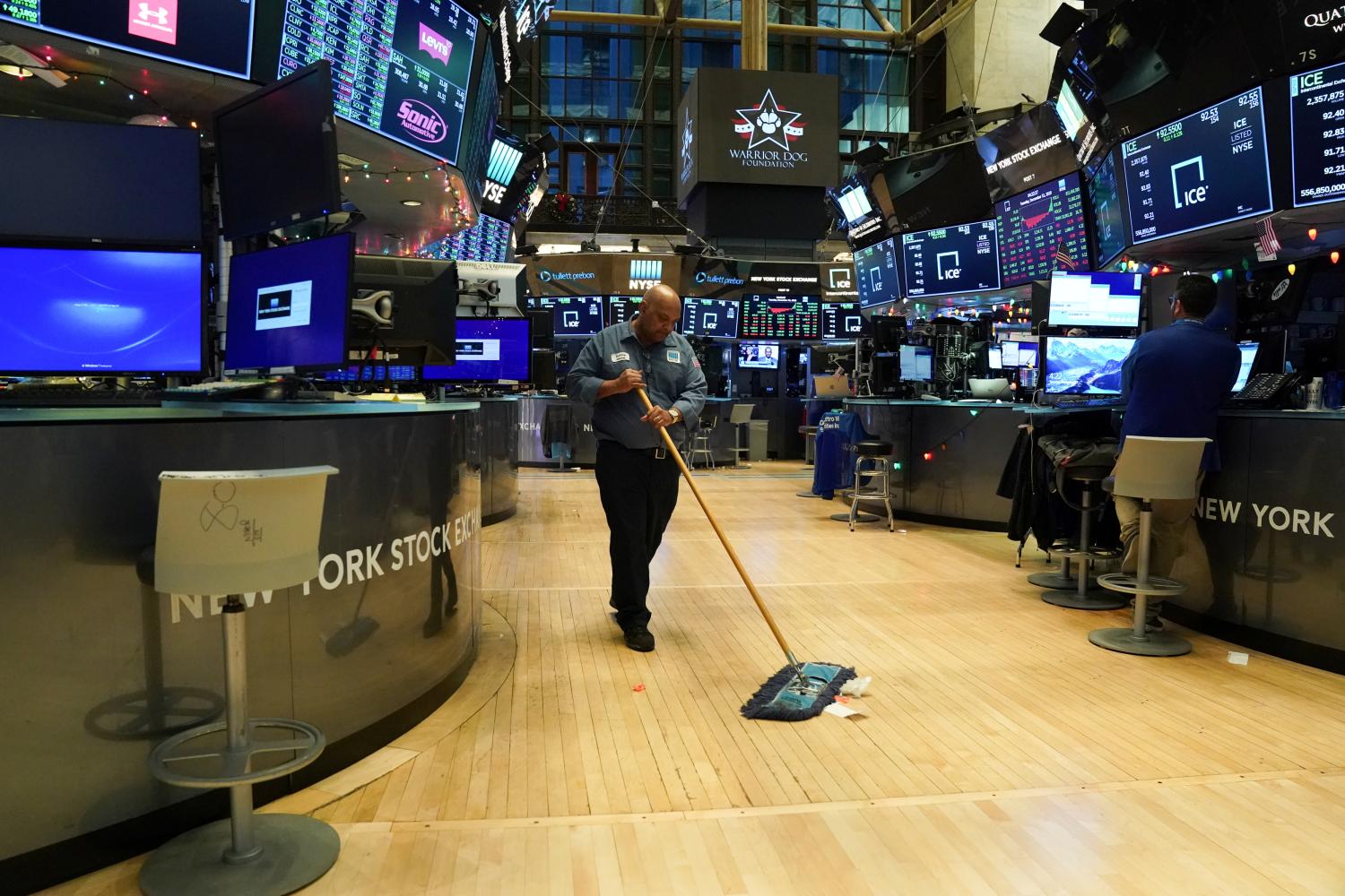 A maintenance worker sweeps the floor after the cling bell at the New York Stock Exchange (NYSE) in New York, U.S., December 31, 2019. REUTERS/Bryan R Smith