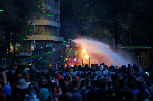 Demonstrators clash with a security forces' water cannon during a protest against Chile's government in Santiago, Chile January 10, 2020. REUTERS/Ivan Alvarado