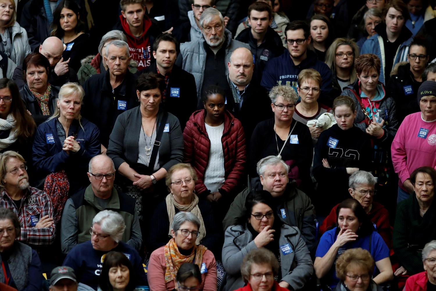 FILE PHOTO: Local residents listen as Democratic 2020 U.S. presidential candidate and former South Bend Mayor Pete Buttigieg speaks during a campaign event in Dubuque, Iowa, U.S., January 22, 2020. REUTERS/Carlos Barria/File Photo