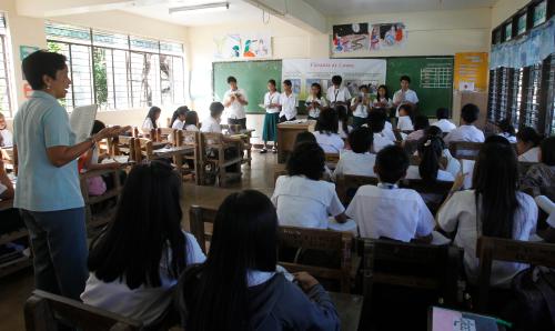 A teacher (L) leads a discussion during classes at a government high school in Muntinlupa, Metro Manila February 17, 2011. The Philippines plans to add two years of schooling to its basic education to try to reclaim a lost advantage over its Asian neighbours, but without a broad overhaul and more funding, the extra time will achieve little. REUTERS/Erik de Castro (PHILIPPINES - Tags: EDUCATION POLITICS)