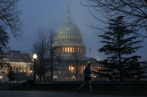 A man runs past the U.S. Capitol dome early in the morning on another day of the continued impeachment inquiry hearings into President Donald Trump's dealings with Ukraine on Capitol Hill in Washington, U.S., December 9, 2019. REUTERS/Loren Elliott