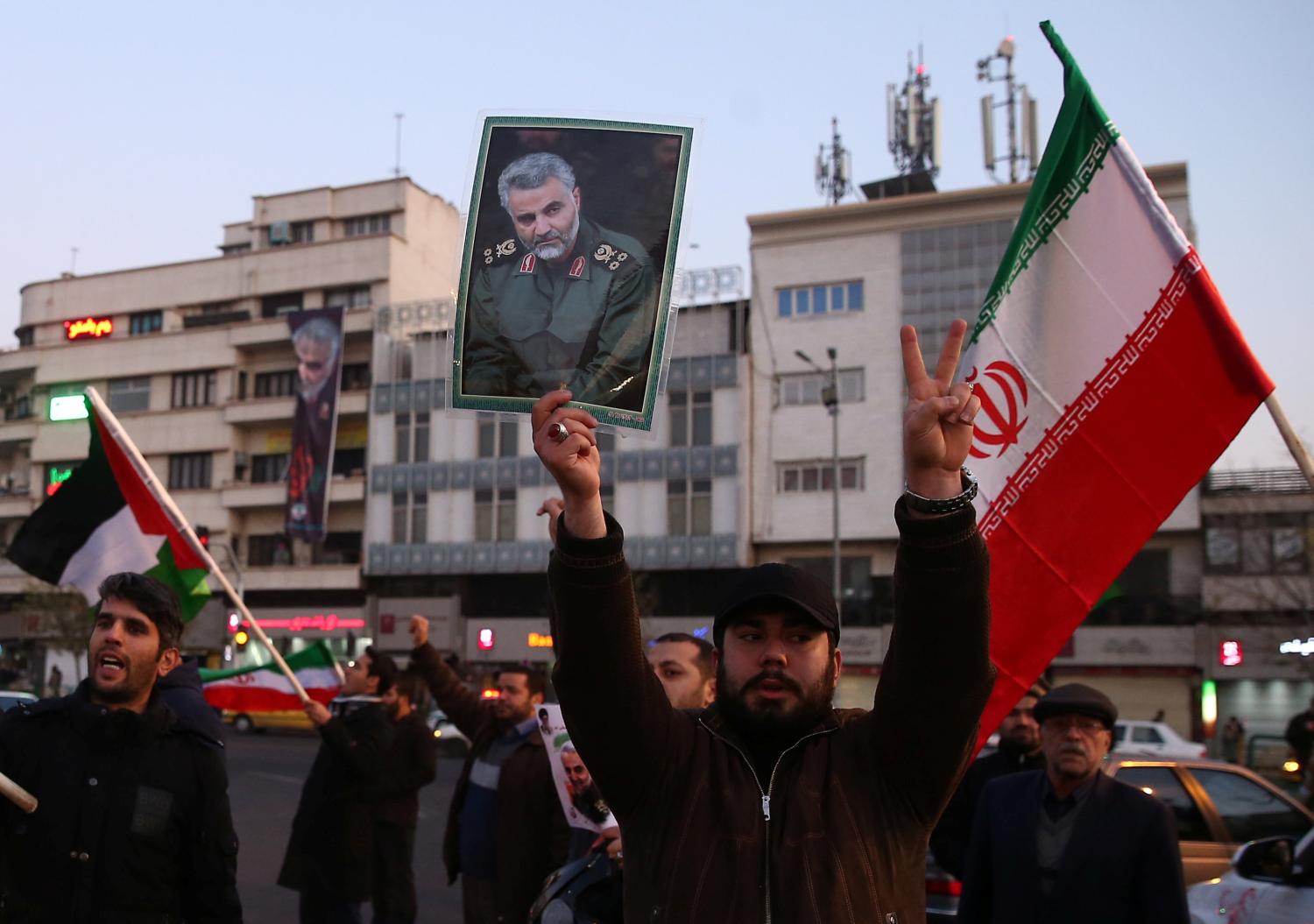 A man holds a picture of late Iranian Major-General Qassem Soleimani, as people celebrate in the street after Iran launched missiles at U.S.-led forces in Iraq, in Tehran, Iran January 8, 2020. Nazanin Tabatabaee/WANA (West Asia News Agency) via REUTERS ATTENTION EDITORS - THIS IMAGE HAS BEEN SUPPLIED BY A THIRD PARTY