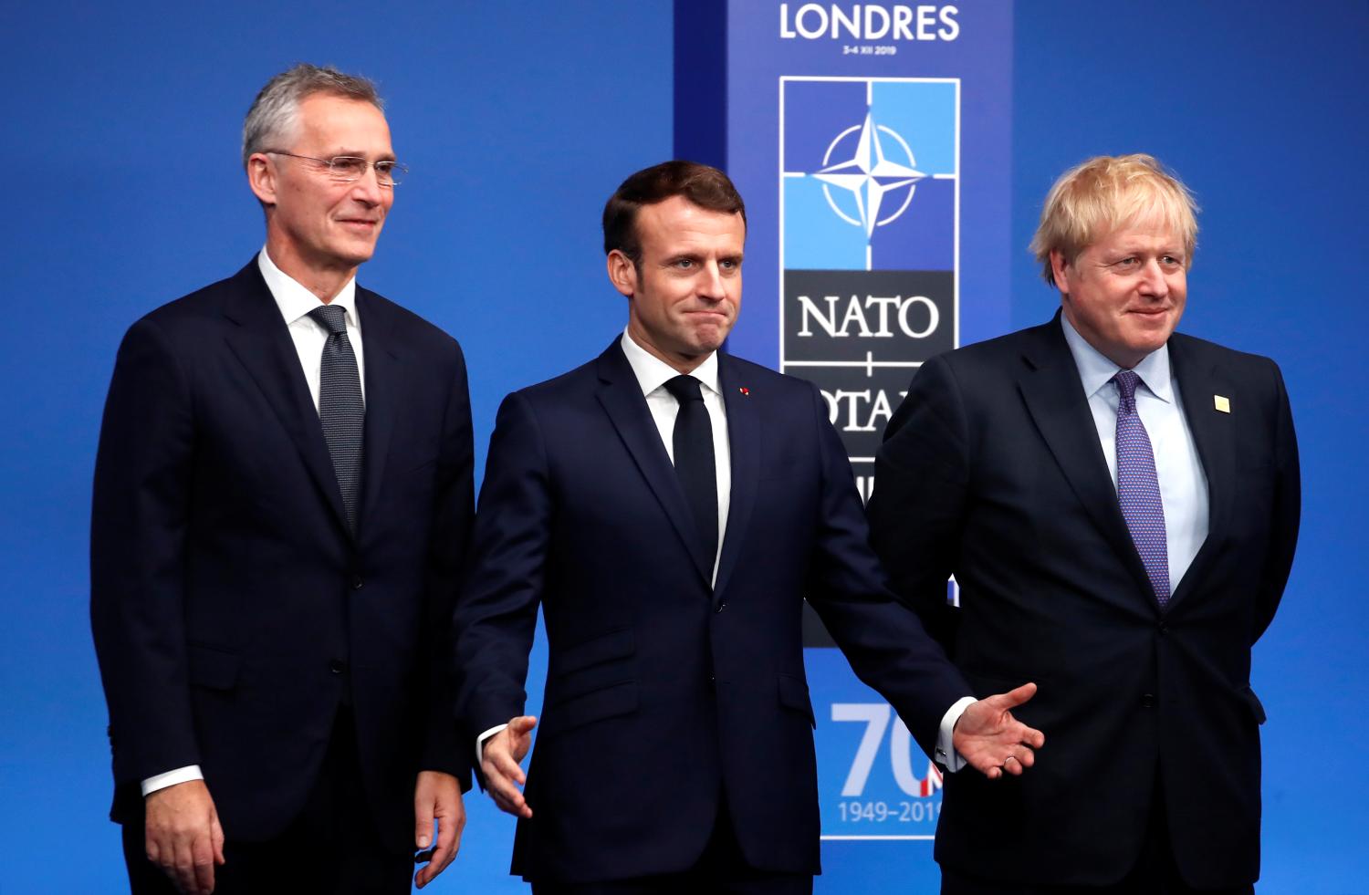 NATO Secretary General Jens Stoltenberg and Britain's Prime Minister Boris Johnson welcome France's President Emmanuel Macron at the NATO leaders summit in Watford, Britain December 4, 2019. REUTERS/Christian Hartmann/Pool