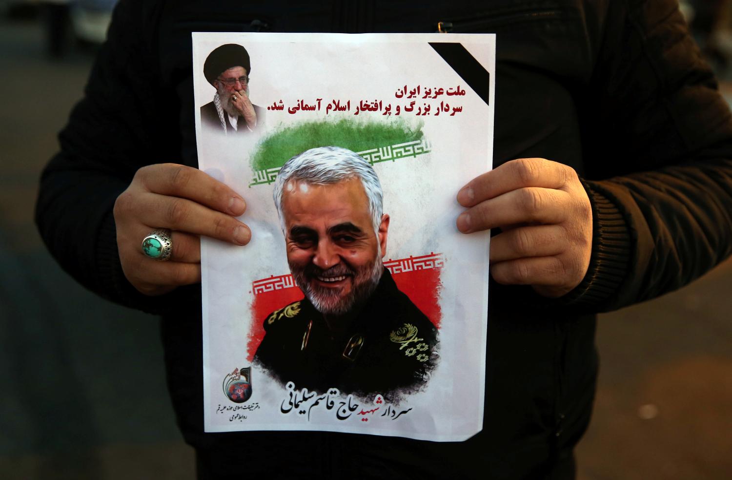 A man holds a picture of late Iranian Major-General Qassem Soleimani, as people celebrate in the street after Iran launched missiles at U.S.-led forces in Iraq, in Tehran, Iran January 8, 2020. Nazanin Tabatabaee/WANA (West Asia News Agency) via REUTERS ATTENTION EDITORS - THIS IMAGE HAS BEEN SUPPLIED BY A THIRD PARTY