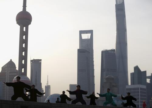 People perform Tai Chi on the Bund in front of the financial district of Pudong in Shanghai, China, March 25, 2016. REUTERS/Aly Song - GF10000359743