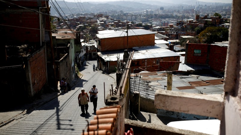 Yaneidi Guzman, 38, walks home with her mother-in-law in Caracas, Venezuela, February 17, 2019. Guzman has lost a third of her weight over the past three years as Venezuela's economic collapse made food unaffordable and she now hopes the opposition will succeed in bringing urgently needed foreign aid. She is one of many Venezuelans suffering from malnutrition. "It's not that I want to be rich, or a millionaire", Guzman said. "But I do want to give my children a good future, to make sure I can take them to the doctors when they get ill... and that they eat well." REUTERS/Carlos Garcia Rawlins  SEARCH "RAWLINS GUZMAN" FOR THIS STORY. SEARCH "WIDER IMAGE" FOR ALL STORIES. - RC1F8A0356E0