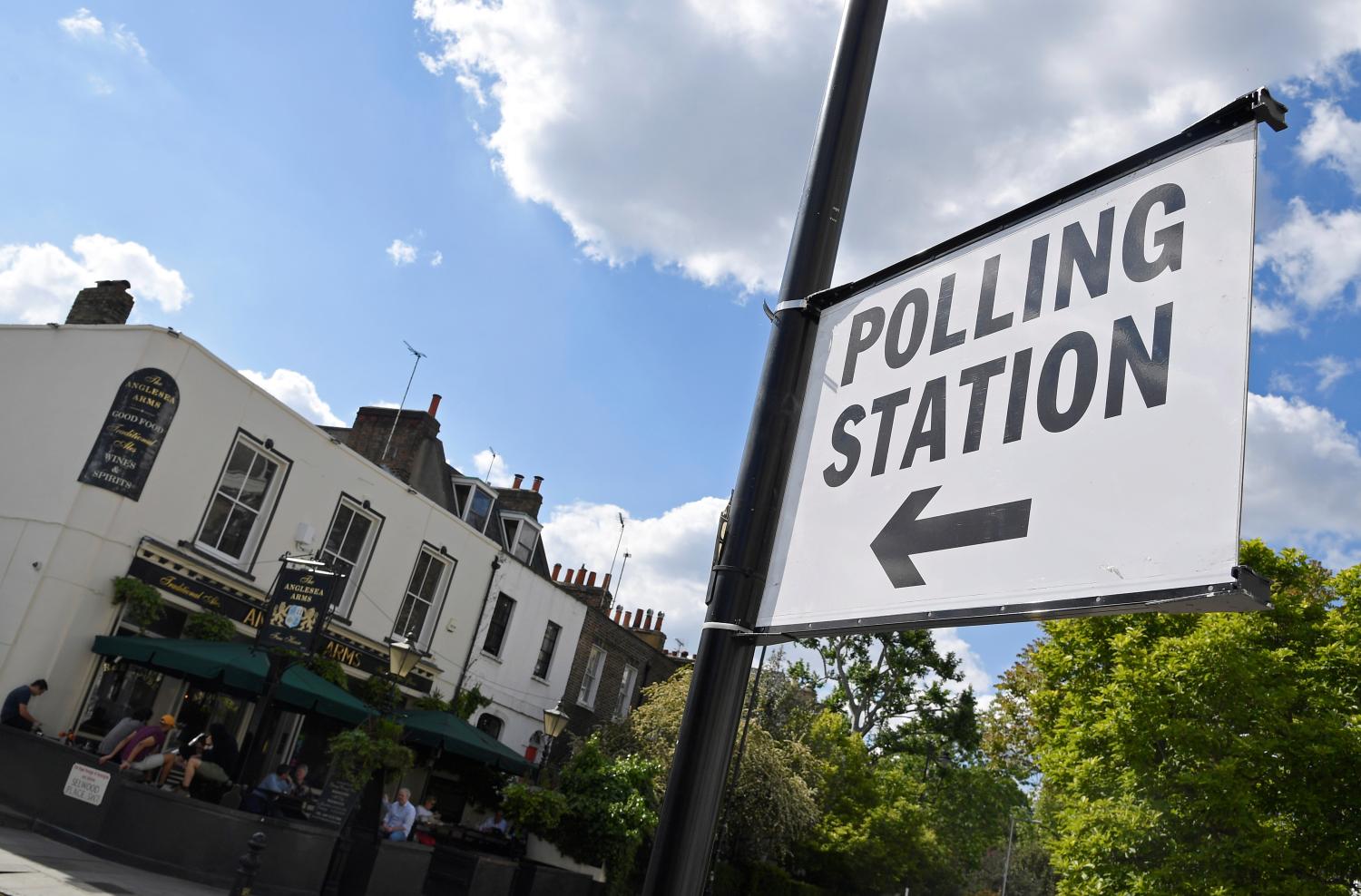 A sign is seen placed on a lamppost next to a pub being used as a polling station for the forthcoming EU elections, in London, Britain, May 21, 2019. REUTERS/Toby Melville - RC1E483EF870