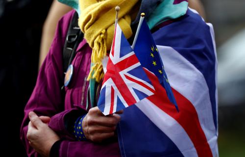 An anti-Brexit demonstrator holds British and European flags during a protest in front of the European Parliament in Brussels, Belgium January 30, 2020. REUTERS/Francois Lenoir