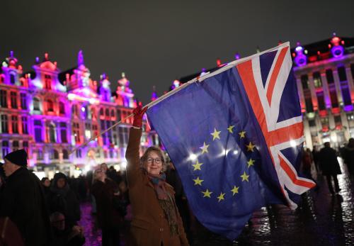 Deirdre Thomas, a resident of Belguim, waving an EU flag and a Union jack in Grand Place in Brussels, Belgium, during a celebration and farewell to the UK on the eve of Brexit.