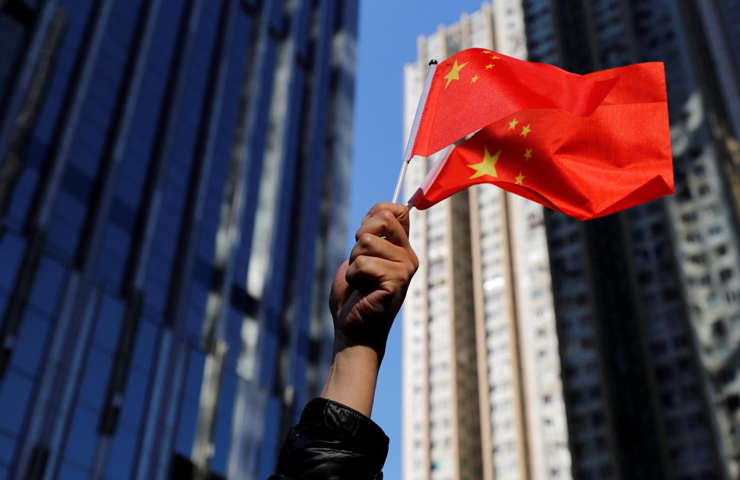 A pro-Beijing supporter holds Chinese national flags during a rally in Hong Kong, China December 7, 2019. REUTERS/Danish Siddiqui