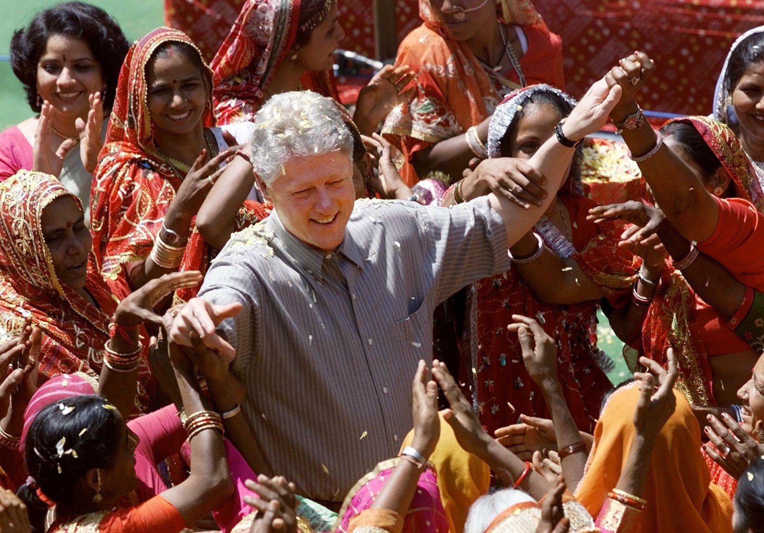 U.S. President Bill Clinton is surrounded by local village women while visiting with members of the governing council of Naila Village in Rajasthan, March 23. [The President is scheduled to finish his visit to India on Saturday when he flies on to Islamabad for a one-day visit. ]