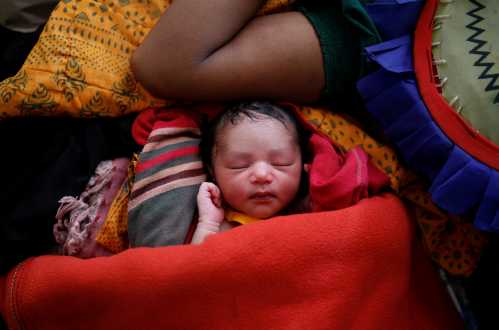 A newborn baby is pictured next to her mother Zahida Begum, 22, a Rohingya refugee after the delivery at a medical centre in Kutupalong refugee camp near Cox's Bazar, Bangladesh October 28, 2017. REUTERS/Adnan Abidi