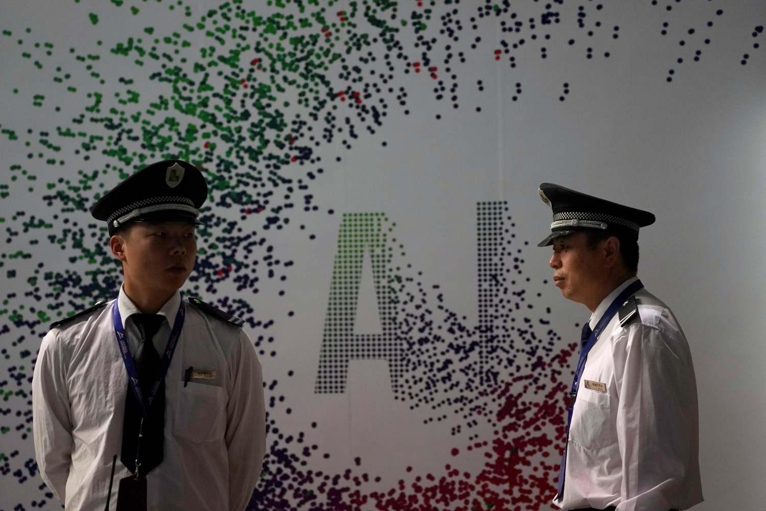 Security officers keep watch in front of an AI (Artificial Intelligence) sign at the annual Huawei Connect event in Shanghai, China September 18, 2019. REUTERS/Aly Song - RC1ADFE7A400