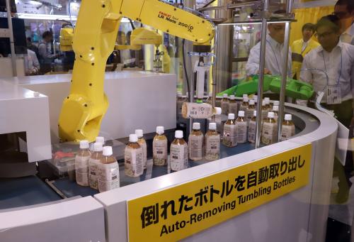 July 11, 2019, Tokyo, Japan - Japanese robot maker Fanuc's arm robot picks and removes a tumbling bottle for a demonstration at the International Food Machinery and Technology Exhibition (FOOMA) in Tokyo on Thursday, July 11, 2019. Some 680 companies exhibit their latest machines for the food processing industry at a four-day trade show.   (Photo by Yoshio Tsunoda/AFLO) No Use China. No Use Taiwan. No Use Korea. No Use Japan.