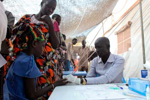 A displaced girl is tested for malaria at an MSF clinic in Tomping camp, where some 17,000 displaced people who fled their homes are being sheltered by the United Nations, in Juba January 10, 2014. Violence erupted in South Sudan's capital Juba in mid-December and spread to oil-producing regions and beyond, dividing the two-year-old land-locked country along ethnic lines. Some 60,000 civilians are being protected at U.N. Bases. REUTERS/Andreea Campeanu (SOUTH SUDAN - Tags: CIVIL UNREST SOCIETY HEALTH)