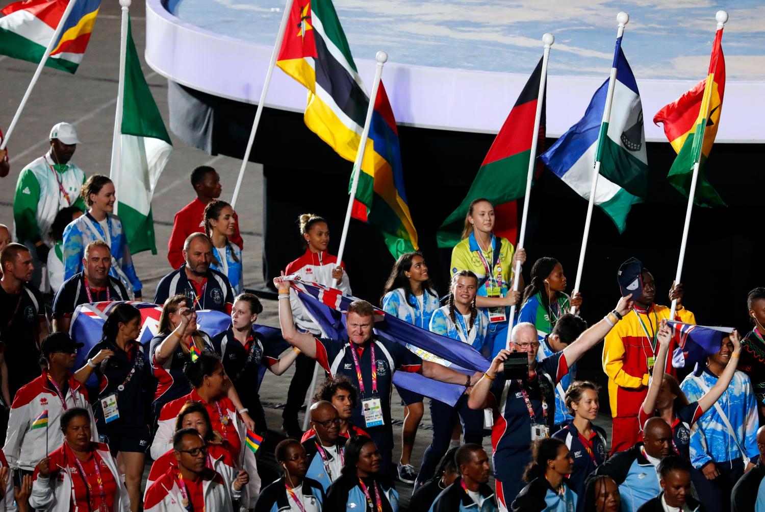 Gold Coast 2018 Commonwealth Games - Closing Ceremony - Carrara Stadium - Gold Coast, Australia - April 15, 2018. Jessie Lartey of Ghana, Roilya Ranaivosoa of Mauritius, Jenito Guezane of Mozambique, Esther Oyama of Nigeria and Esther Oyama of Nigeria  carry the national flags as they walk among athletes and staff members. REUTERS/David Gray