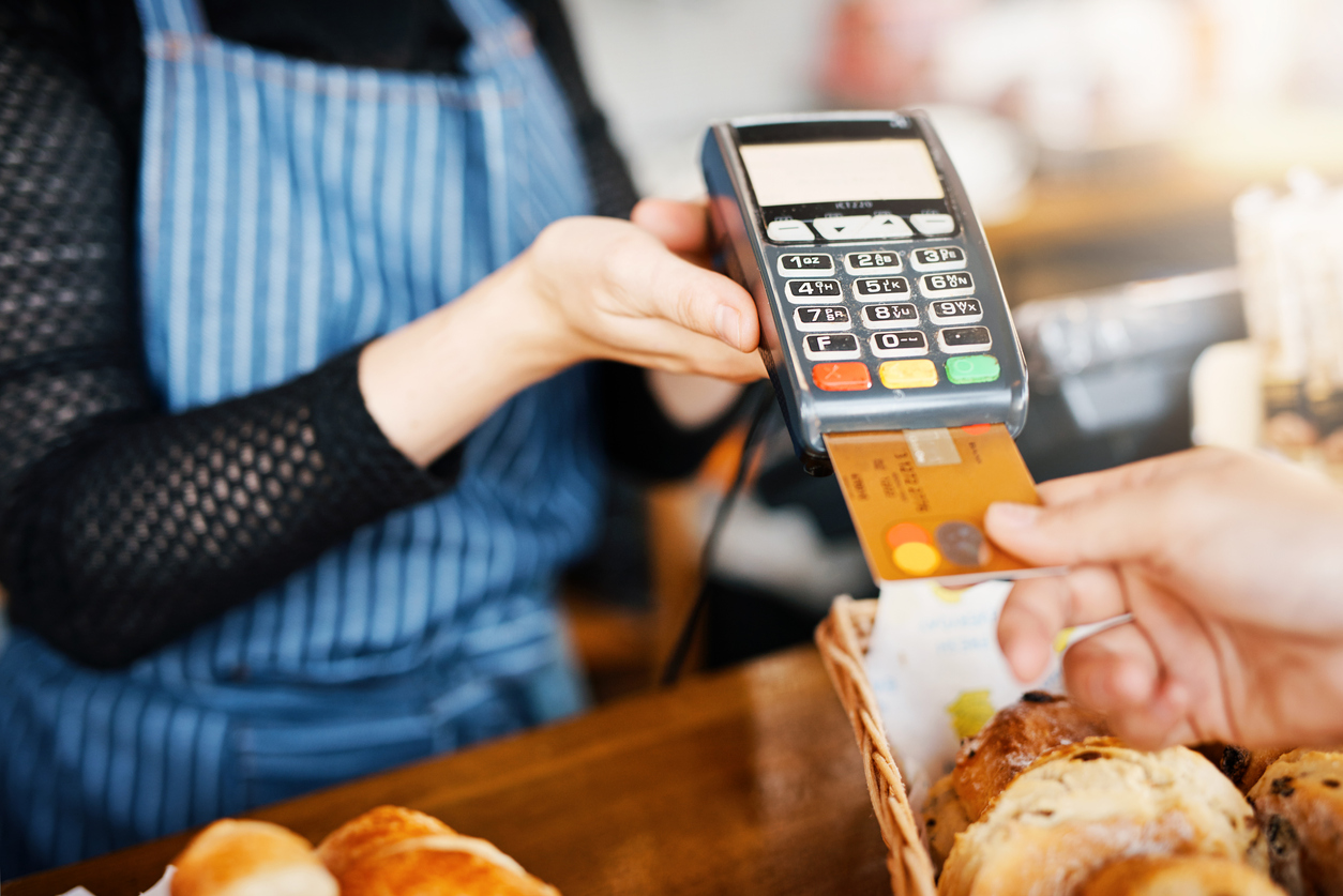 Cropped shot of an unrecognizable man paying for his purchase by card