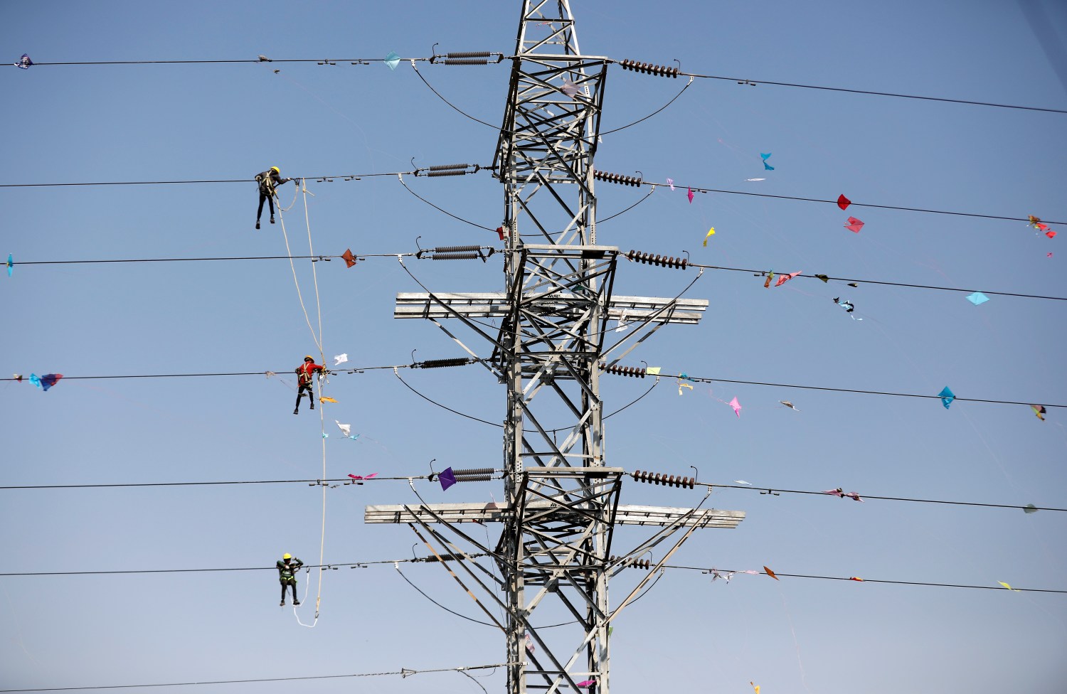Workers of Torrent Power Limited remove kites and thread tangled up in electric power cables after the end of the kite flying season in Ahmedabad, India, January 16, 2020. REUTERS/Amit Dave     TPX IMAGES OF THE DAY