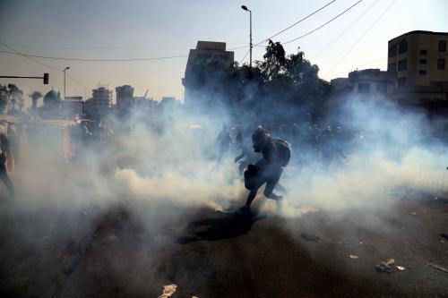 Demonstrators run from tear gas thrown at them during ongoing anti-government protests in Baghdad, Iraq January 28, 2020. REUTERS/Abdullah Dhiaa al-Deen     TPX IMAGES OF THE DAY