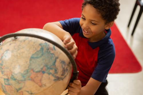 Child looking at globe