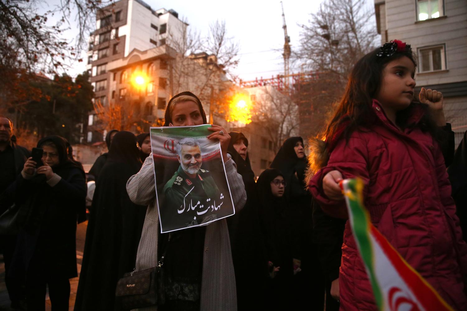 An Iranian demonstrator holds a picture of the late Iranian Major-General Qassem Soleimani, during a protest against the assassination of Soleimani, head of the elite Quds Force, and Iraqi militia commander Abu Mahdi al-Muhandis, who were killed in an air strike at Baghdad airport, in front of United Nation office in Tehran, Iran January 3, 2020. Nazanin Tabatabaee/WANA (West Asia News Agency) via REUTERS ATTENTION EDITORS - THIS IMAGE HAS BEEN SUPPLIED BY A THIRD PARTY.