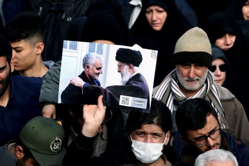 A demonstrator holds a picture of Supreme Leader Ayatollah Ali Khamenei with Iranian Major-General Qassem Soleimani, during protest against the assassination of Soleimani, head of the elite Quds Force, and Iraqi militia commander Abu Mahdi al-Muhandis who were killed in an air strike in Baghdad airport, in Tehran, Iran January 3, 2020. WANA (West Asia News Agency)/Nazanin Tabatabaee via REUTERS ATTENTION EDITORS - THIS IMAGE HAS BEEN SUPPLIED BY A THIRD PARTY.