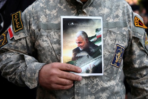 A demonstrator holds the picture of Qassem Soleimani during a protest against the assassination of the Iranian Major-General Qassem Soleimani, head of the elite Quds Force, and Iraqi militia commander Abu Mahdi al-Muhandis who were killed in an air strike in Baghdad airport, in Tehran, Iran January 3, 2020. WANA (West Asia News Agency)/Nazanin Tabatabaee via REUTERS ATTENTION EDITORS - THIS IMAGE HAS BEEN SUPPLIED BY A THIRD PARTY.     TPX IMAGES OF THE DAY