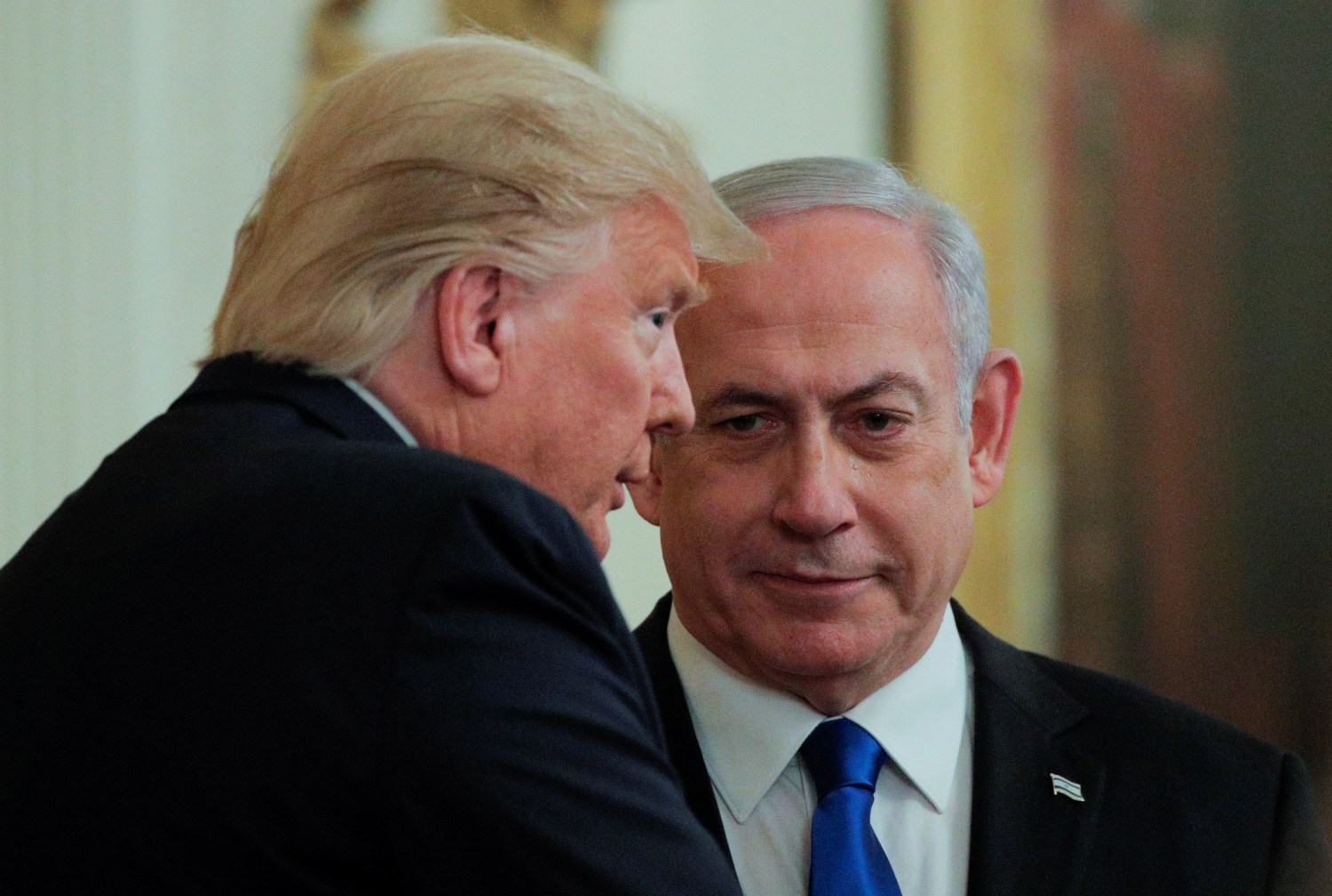 U.S. President Donald Trump and Israel's Prime Minister Benjamin Netanyahu talk in the midst of a joint news conference on a new Middle East peace plan proposal in the East Room of the White House in Washington, U.S., January 28, 2020. REUTERS/Brendan McDermid