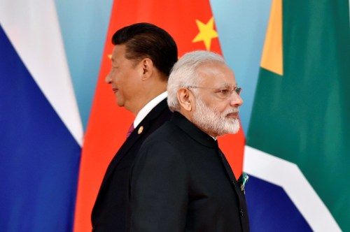 Chinese President Xi Jinping (L) and Indian Prime Minister Narendra Modi attend the group photo session during the BRICS Summit at the Xiamen International Conference and Exhibition Center in Xiamen, southeastern China's Fujian Province, China September 4, 2017. REUTERS/Kenzaburo Fukuhara/Pool