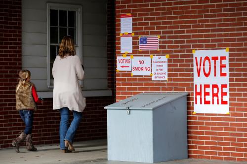 Anna Atkinson walks into a polling station with her 8-year-old daughter Tori, in Gallant, Alabama, U.S., December 12, 2017.  REUTERS/Jonathan Bachman