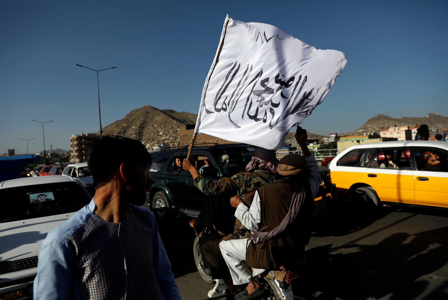 Taliban ride on a motorbike in Kabul, Afghanistan June 16, 2018. The writing on the flag reads: 'There is no god but Allah, Muhammad is the messenger of Allah'. REUTERS/Mohammad Ismail